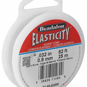 May include: A spool of white Beadalon Elasticity elastic cord, 0.032 inches in diameter, 82 feet long. The label reads "Beadalon Elasticity Elastic Cord, Cordon Elastique, Cordon Elastico, Satin Silver, Argenté Satiné, Plateado Satina, 0.032 in, 0.8 mm, 82 ft, 25 m, 35926 11460 9, JE0.88-0026M".