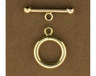 May include: Gold-toned metal toggle clasp with a round ring and a straight bar with rounded ends.