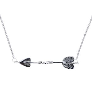 May include: A silver necklace with an arrow pendant. The arrow has a detailed design and is accented with small beads.