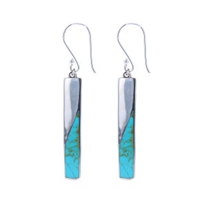 May include: A pair of silver dangle earrings with turquoise stones. The turquoise stones are set in a silver bar shape and are a light blue colour.
