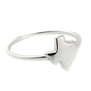 May include: A silver ring with a Texas state outline design.