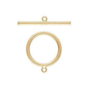 May include: Gold-toned metal toggle clasp with a round ring and a straight bar. The clasp is used for necklaces, bracelets, and other jewelry.