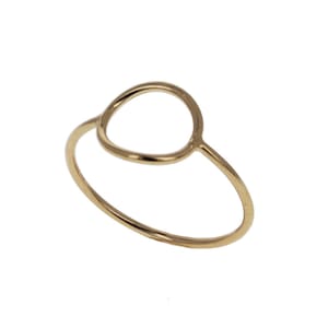 May include: A gold-toned ring with a simple circle design. The ring is made of metal and has a smooth finish.