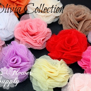 May include: A collection of colorful fabric flowers in various shades, including white, pink, red, and yellow. The flowers are made of layered tulle, with the text "Olivia Collection" and "Lily's Flower Supply" in the image.