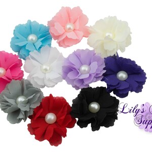 May include: Assortment of ten small fabric flowers with pearl centers in various colors, including pink, blue, purple, white, gray, and black.