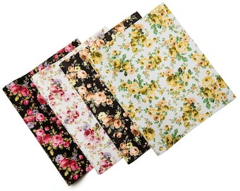 May include: Four fabric sheets with floral patterns. The sheets are in different colors and patterns, including black with pink flowers, white with purple flowers, beige with orange flowers, and white with yellow flowers.