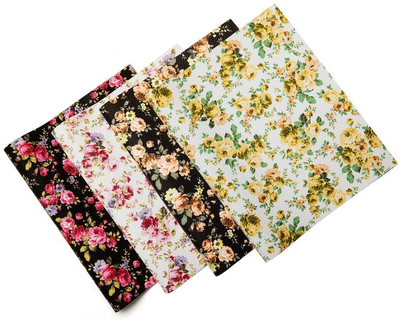 May include: Four sheets of fabric with floral patterns. The fabric is in various colors, including black, white, and pink. The floral patterns are all different, but they all feature roses.