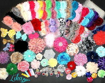 May include: A collection of colorful fabric flowers, bows, and embellishments in various sizes and styles. The assortment includes rosettes, layered flowers, and bows in shades of pink, red, yellow, blue, and more. Some have rhinestone and pearl accents.
