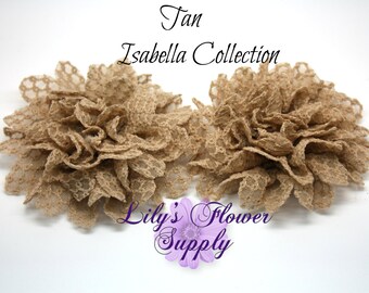 May include: Two tan lace flower embellishments from the Isabella Collection. The flowers are made of layered, ruffled lace, and are set against a white background. The text "Tan Isabella Collection" and "Lily's Flower Supply" are visible.
