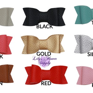 Puede incluir: Nueve lazos para el pelo de imitación de cuero en varios colores, incluyendo beige, negro, turquesa, rosa intenso, dorado, plateado, marrón, rojo y rosa.  Lily's Flower Supply está impreso debajo del lazo dorado.