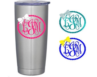 May include: A stainless steel tumbler with a pink, blue, or yellow monogram with a bow on top. The monogram is surrounded by a circle of pearls.