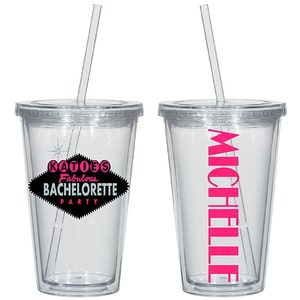 May include: Two clear plastic tumblers with lids and straws. One tumbler has the text "KATIE'S Fabulous BACHELORETTE PARTY" in black and pink on a black diamond shape. The other tumbler has the name "MICHELLE" in pink.