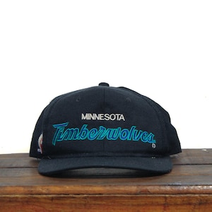 May include: Black baseball cap with the text "MINNESOTA Timberwolves" embroidered in white and blue.