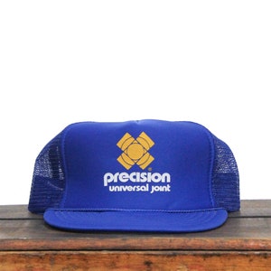 May include: A blue and yellow trucker hat with the words "precision universal joint" on the front.