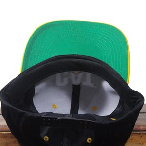 May include: A white ceramic mug with a black handle and the text "But First, Coffee" in a black, bold font. The mug is sitting on a wooden surface. The mug is approximately 4 inches tall.