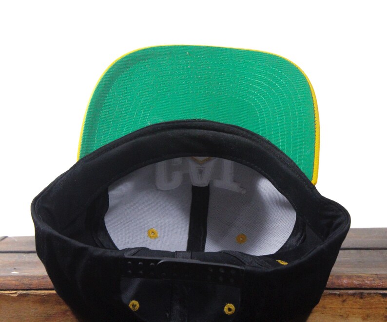 May include: A white ceramic mug with a black handle and the text "But First, Coffee" in a black, bold font. The mug is sitting on a wooden surface. The mug is approximately 4 inches tall.