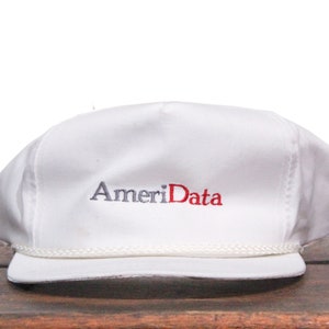 May include: White baseball cap with a white rope trim and the embroidered text "AmeriData" in gray and red.