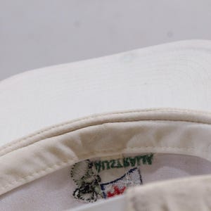 May include: White baseball cap with a green and white embroidered logo that says "ALWAYZWIN".