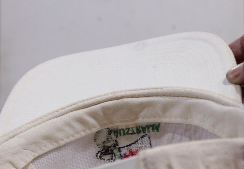 May include: White baseball cap with a green and white embroidered logo that says "ALWAYZWIN".