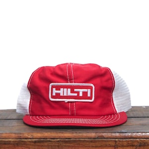 May include: A red and white mesh trucker hat with a white "HILTI" logo patch.