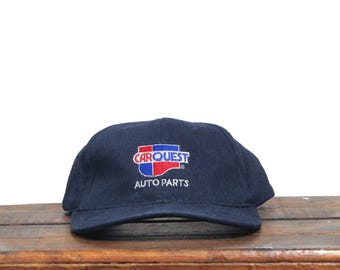 May include: A black baseball cap with the Carquest Auto Parts logo embroidered in red, blue, and white.