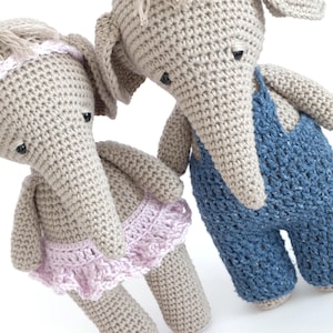 May include: Two crocheted elephant toys. One elephant is wearing a pink tutu and the other is wearing blue overalls.