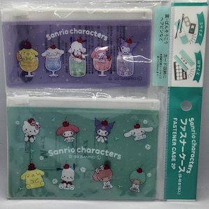 May include: Two Sanrio characters fastener cases in a clear plastic package. One case is purple with cartoon characters in drinks, the other is green with Sanrio characters. The package also includes a card and hair accessories.