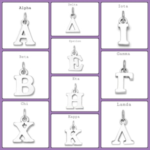 May include: A set of silver charms featuring the Greek alphabet letters. Each charm is a different letter, from Alpha to Lambda. The charms are on a white background.