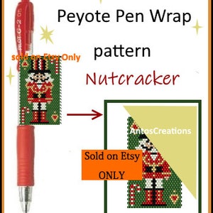 May include: A red pen with a beaded nutcracker design wrapped around it. The beadwork is in green, red, white, and gold colours. The image includes the text "Peyote Pen Wrap pattern Nutcracker Sold on Etsy ONLY".