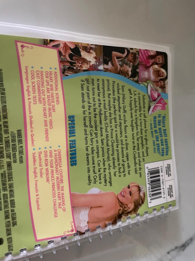 May include: DVD cover for the movie "A Cinderella Story" featuring Hilary Duff. The cover is green with a pink and white Cinderella-themed design. The text "Hilary Duff sparkles in the must-see toon movie of the year!" is printed on the cover.