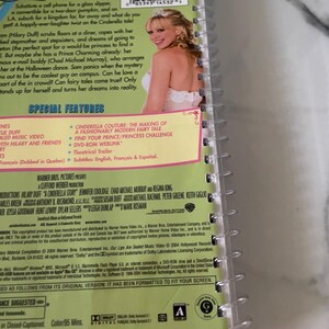 May include: DVD cover for the movie "A Cinderella Story" featuring Hilary Duff, Chad Michael Murray, and Jennifer Coolidge. The cover is pink and green with a white border. The title of the movie is in large, white letters. The cover also includes a barcode and a list of special features.