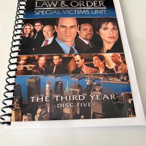 May include: A spiral-bound booklet featuring the Law & Order Special Victims Unit The Third Year Disc Five cover art. The front displays cast members, a city skyline, and the show title in white and blue text against a dark background.
