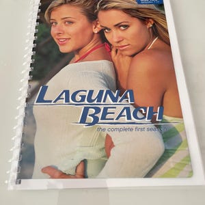 May include: A spiral-bound DVD set featuring two women. The cover displays the text "LAGUNA BEACH" in blue and white, with "the complete first season" below. The top right corner reads "disc two episodes 7-11".