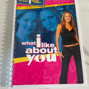 May include: A pink and blue DVD case with the text "The Complete First Season" and "What I Like About You" on the front. The case features a photo of three women.
