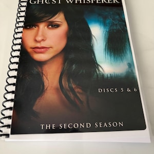 May include: A spiral-bound media case for Ghost Whisperer The Second Season, Discs 5 & 6. The cover features a portrait of Jennifer Love Hewitt against a dark, moody background with a silhouette of a tree and text in white and gold lettering.