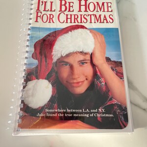 May include: A VHS tape cover for the Disney movie "I'll Be Home for Christmas" starring Jonathan Taylor Thomas. The cover features a young man wearing a Santa hat and a plaid shirt.