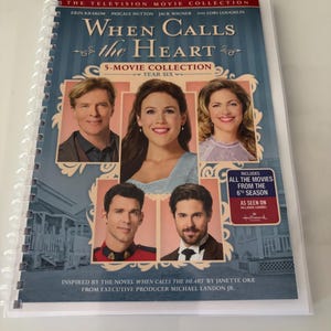 May include: A spiral-bound DVD collection titled When Calls the Heart Year Six, featuring five movies. The cover displays portraits of five actors, the text The Television Movie Collection, and a badge stating it includes all movies from the 6th season.