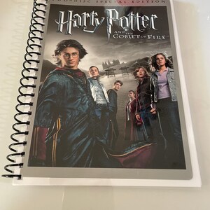 May include: A two-disc special edition DVD case for the movie "Harry Potter and the Goblet of Fire". The case features a silver background with the movie title in black and a photo of the main characters from the film.