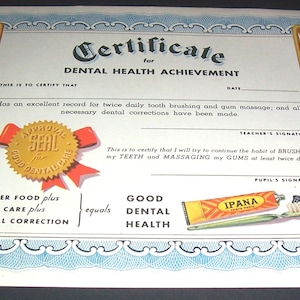May include: A certificate for dental health achievement with a gold seal and a red ribbon. The certificate states "This is to certify that... has an excellent record for twice daily tooth brushing and gum massage, and all necessary dental corrections have been made." It also includes a picture of a tube of Ipane Tooth Paste and a toothbrush.