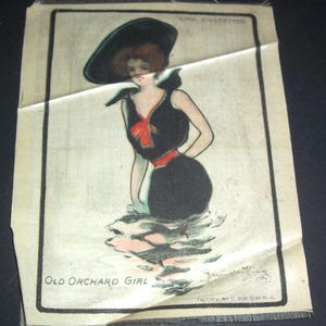 May include: Vintage illustration of a woman in a black swimsuit and hat, standing in water. The image, titled "Old Orchard Girl," features a red bow and belt, with text at the top and bottom. The artwork is on a textured, off-white background.