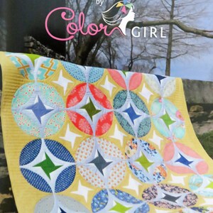 May include: A quilt pattern called "Eclipse" by Color Girl featuring a yellow background with colorful circles and stars.