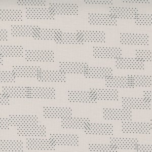 May include: A white fabric with a repeating pattern of black dots arranged in geometric shapes. The pattern is abstract and modern.