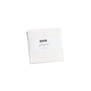 May include: A white fabric square with a label that reads "moda fabric whispers by studio e".