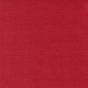 May include: A solid red textured background with a fine woven pattern.