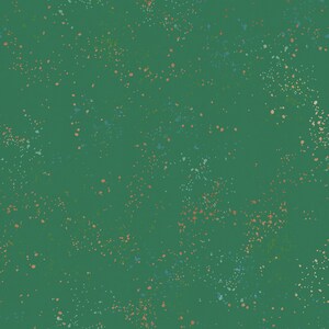 May include: A green background with a scattered pattern of small, colorful dots. The dots are in shades of blue, orange, and green.