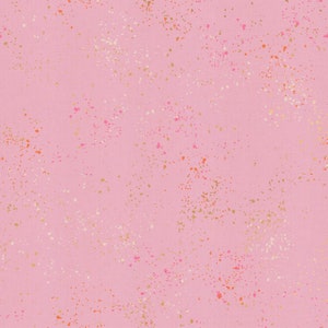 May include: A pink fabric with a speckled pattern of gold, white, and pink dots.