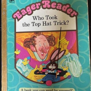 May include: A vintage Little Golden Book titled "Eager Reader: Who Took the Top Hat Trick?" features a colorful illustration of a magician, a rabbit, and other whimsical characters. The cover is framed by a turquoise border with a gold spine.