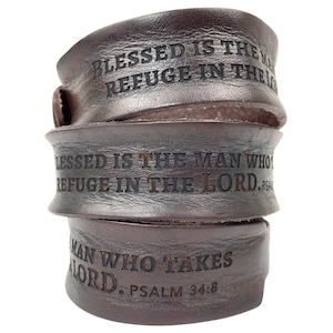 May include: Brown leather bracelet with the words "Blessed is the man who takes refuge in the Lord. Psalm 34:8" engraved on it.