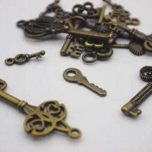 May include: A collection of antique-style keys in a bronze finish. The keys are various sizes and shapes, with intricate details and ornate designs.