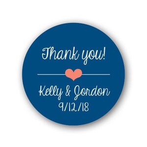 May include: A round blue thank you sticker with a white heart and the text "Thank you! Kelly & Gordon 9/12/18"